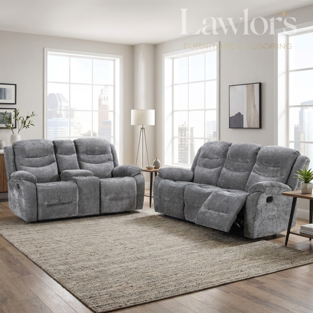 A grey 2 seater and a matching grey 3 seater recliner sofa set with centre armrests, shown in a bright modern living room with large windows, a beige rug, and wood flooring.