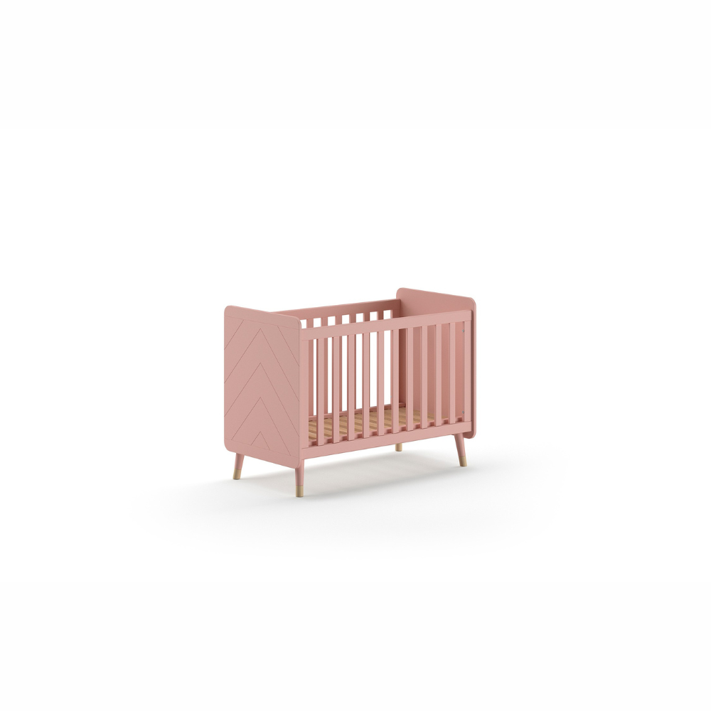 The Billy Baby Cot Bed in Terra Pink features a geometric graphic design, golden accents and an adjustable slatted base, perfect for a modern nursery setup