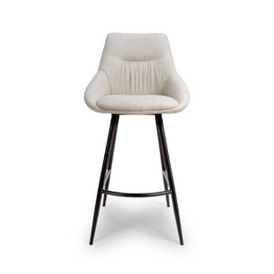 The Boden Bar Chair in Sage Green, Natural or Brick offers luxurious fabric comfort, chic pleated details, robust black metal legs