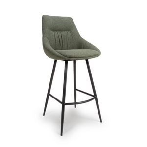 The Boden Bar Chair in Sage Green offers luxurious fabric comfort, chic pleated details, robust black metal legs