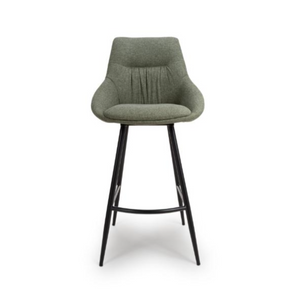 The Boden Bar Chair in Sage Green offers luxurious fabric comfort, chic pleated details, robust black metal legs