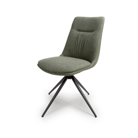 The Boden Chair in Sage Green features soft fabric upholstery, pleated accents, robust black metal legs along