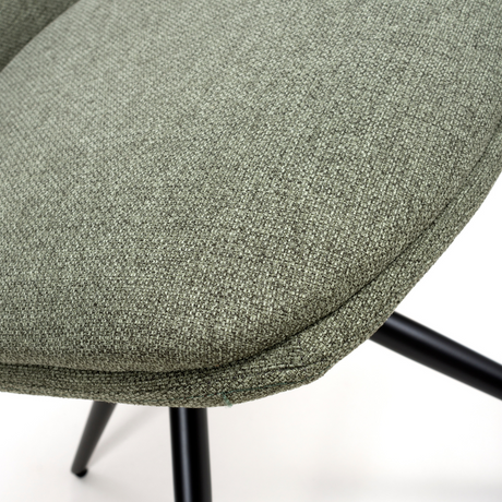 The Boden Chair in Sage Green features soft fabric upholstery, pleated accents, robust black metal legs along