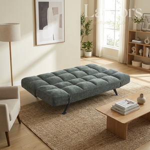 Green sofa bed in a living room setting with a coffee table and decor items.