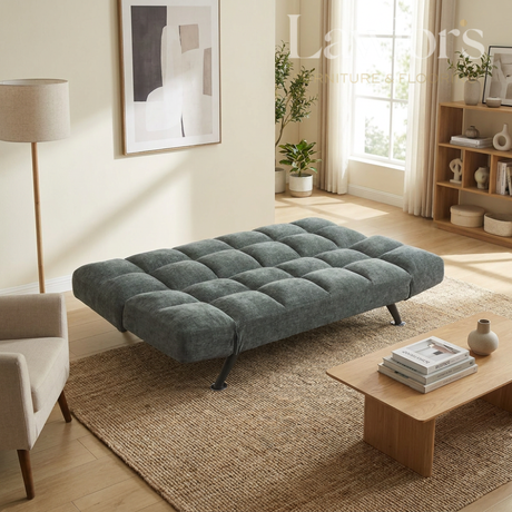 Green sofa bed in a living room setting with a coffee table and decor items.