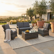 Outdoor garden furniture patio set with furniture and decor on a patio area.