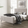 The Clarissa Bed in Grey or Beige features chic channelled upholstery, sturdy metal legs, and padded headboard.