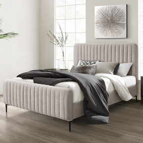 The Clarissa Bed in Grey or Beige features chic channelled upholstery, sturdy metal legs, and padded headboard.