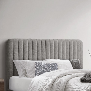 The Clarissa Bed in Grey or Beige features chic channelled upholstery, sturdy metal legs, and padded headboard.