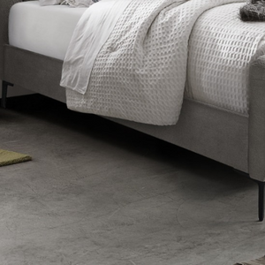 The Clarissa Bed in Grey or Beige features chic channelled upholstery, sturdy metal legs, and padded headboard.