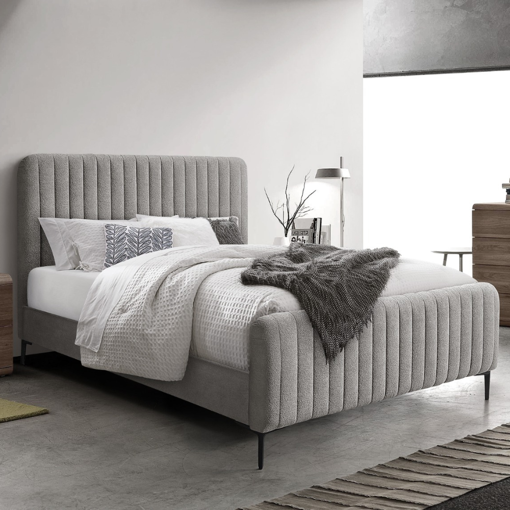 The Clarissa Bed in Grey or Beige features chic channelled upholstery, sturdy metal legs, and padded headboard.