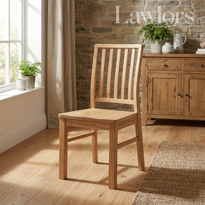 Wooden chair in a room with stone wall