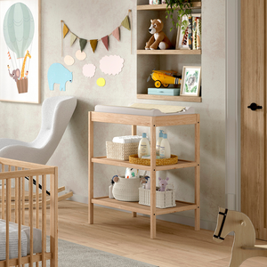 The Dino Baby Changing Table in Natural features a European beech material with open shelves, making it easily accessible for baby essentials