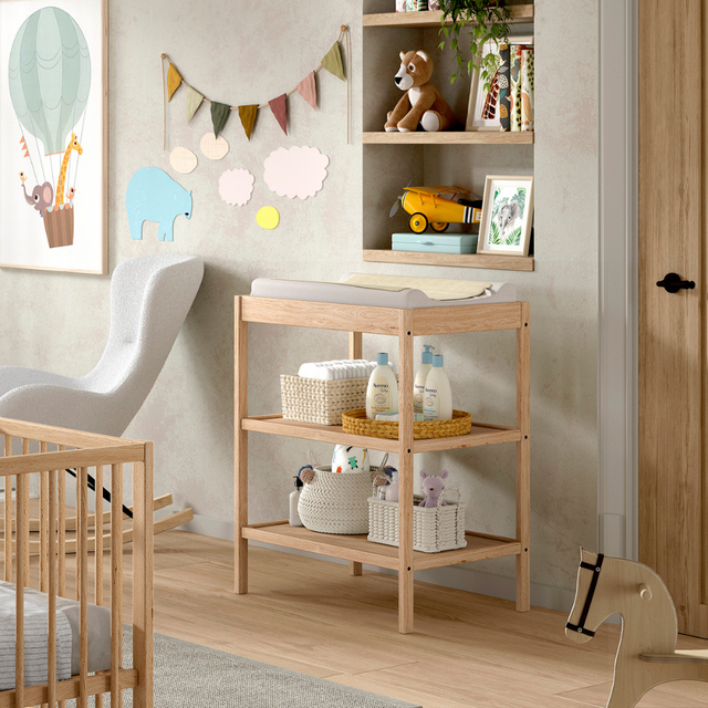 The Dino Baby Changing Table in Natural features a European beech material with open shelves, making it easily accessible for baby essentials