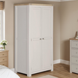The Doune 2-Door Wardrobe in Taupe features oak veneer top, spacious hanging rail, and sleek metal handles.