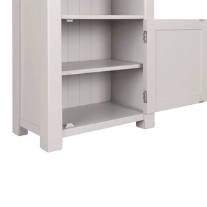 The Doune Tall Bookcase in Taupe features sleek design, oak veneer top and a hidden cabinet storage.