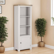 The Doune Tall Bookcase in Taupe features sleek design, oak veneer top and a hidden cabinet storage.