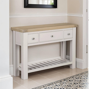 The Doune Console Table in Taupe features a sleek taupe finish, design with three drawers and a lower slatted shelf.
