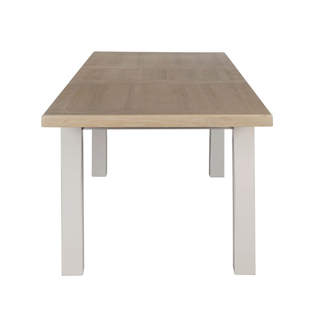 The Doune Extendable Dining Table in Taupe, 1800-2460mm features oak top, taupe-painted legs, and smooth extension mechanism.