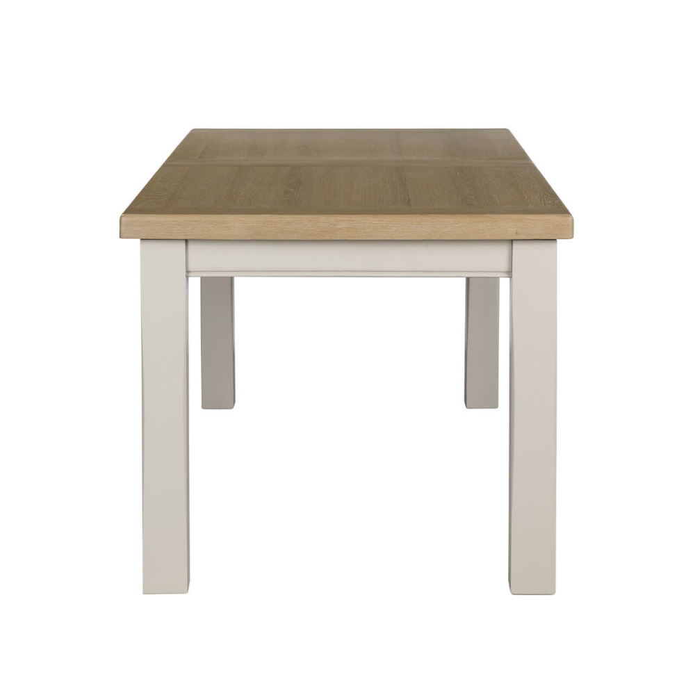 The Doune Extendable Dining Table in Taupe, 1800-2460mm features oak top, taupe-painted legs, and smooth extension mechanism.