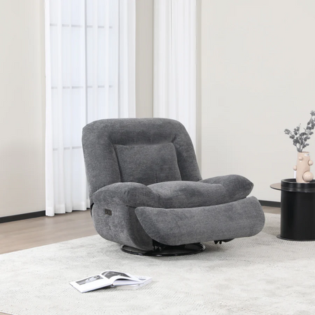 The Ebba Recliner Chair in Dark Grey is upholstered in flat bouclé fabric, swivel function and electric recline for adjusting.