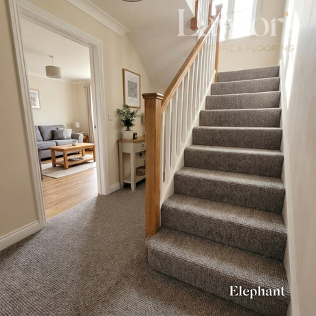 Staircase with carpeted steps leading to a living room