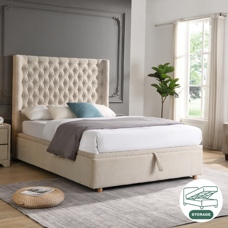 The Emma Gas-Lift Fabric Ottoman features soft-touch beige fabric, soft button details, convenient storage and subtly winged sides.