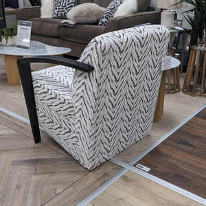 The Falcon Accent Chair features a bold patterned fabric, sleek black wooden arms and deep cushioning for a stylish and comfortable statement to any room