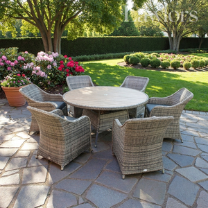 Garden furniture patio set with round table and chairs on a stone patio with garden in the background