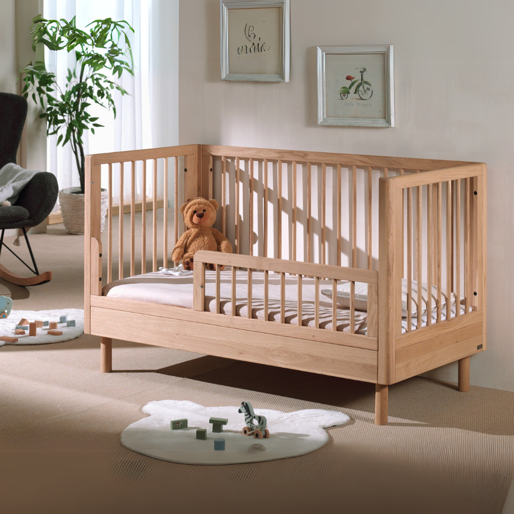 The Forrest Convertible Baby Bed 70 x 140cm in Oak transforms into a toddler bed for extended use & adjustable base with 3 heights, ideal for growing kids