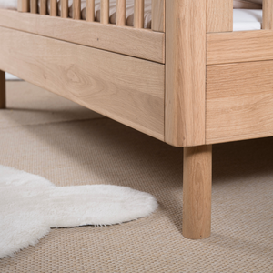 The Forrest Convertible Baby Bed 70 x 140cm in Oak transforms into a toddler bed for extended use & adjustable base with 3 heights, ideal for growing kids