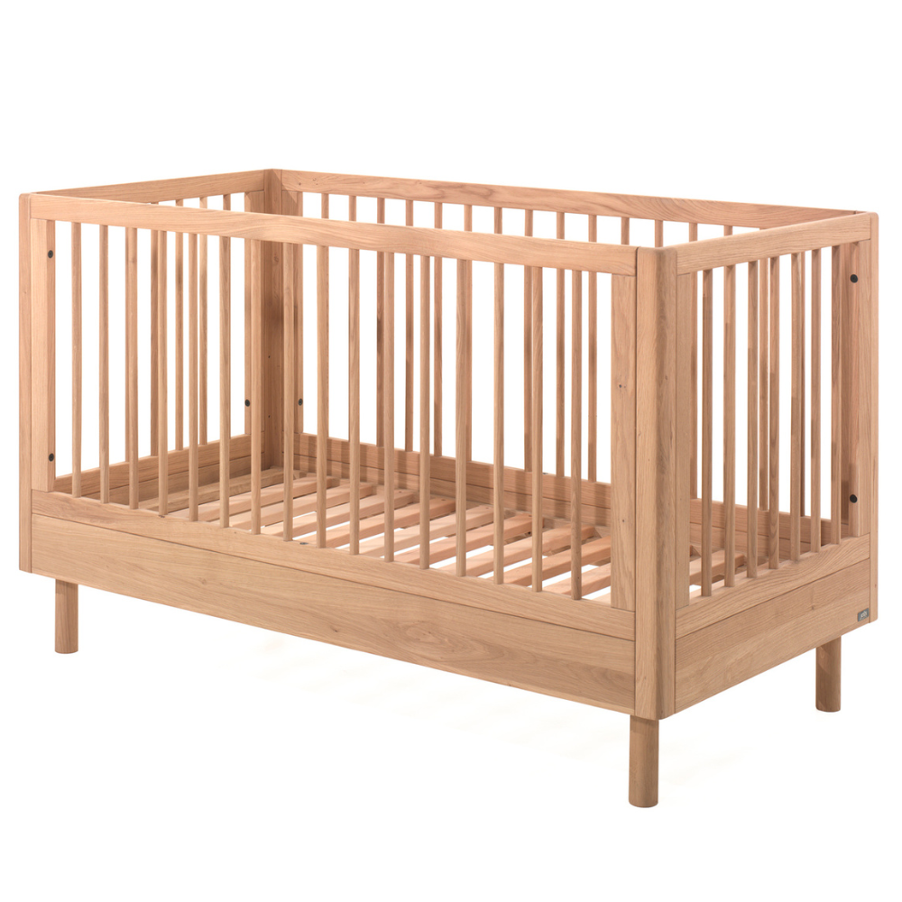 The Forrest Convertible Baby Bed 70 x 140cm in Oak transforms into a toddler bed for extended use & adjustable base with 3 heights, ideal for growing kids
