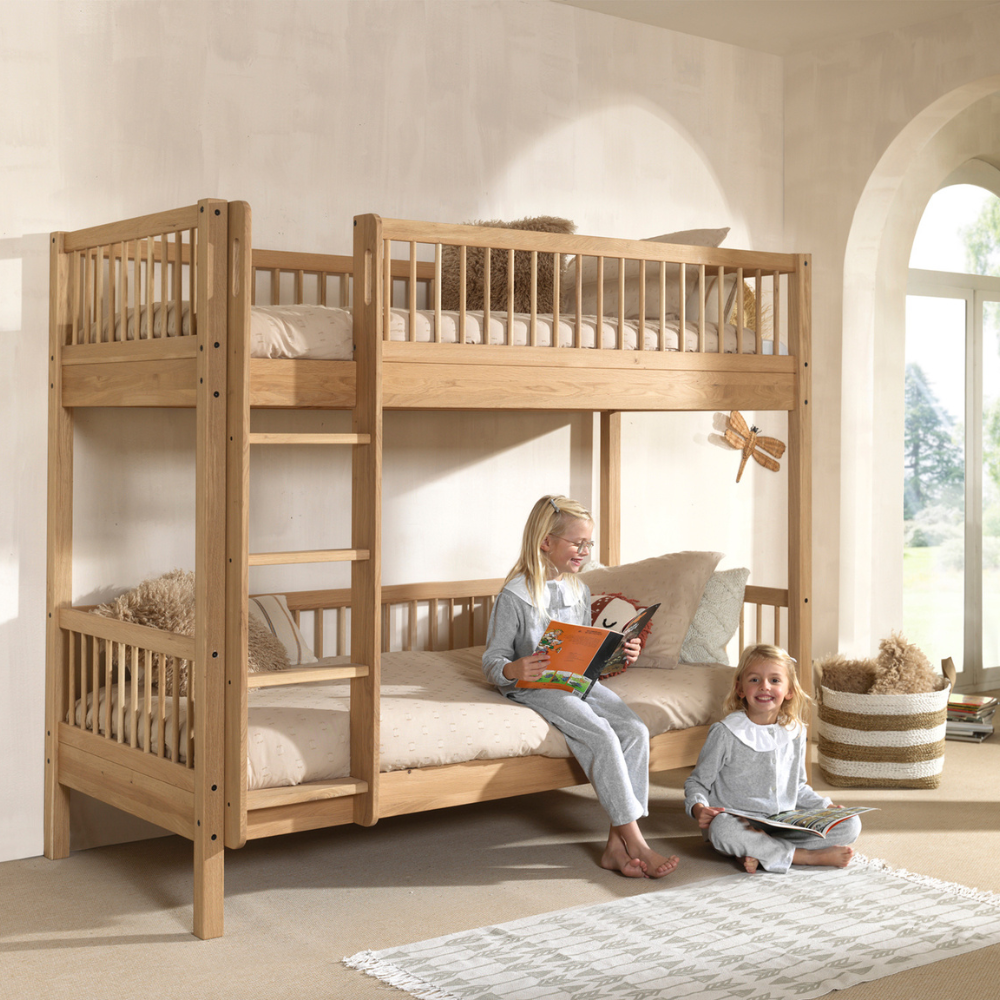 The Forrest Oak Kids Bunk Bed with Drawer provides strong oak material while providing ample storage space and ladder that can be positioned on either side