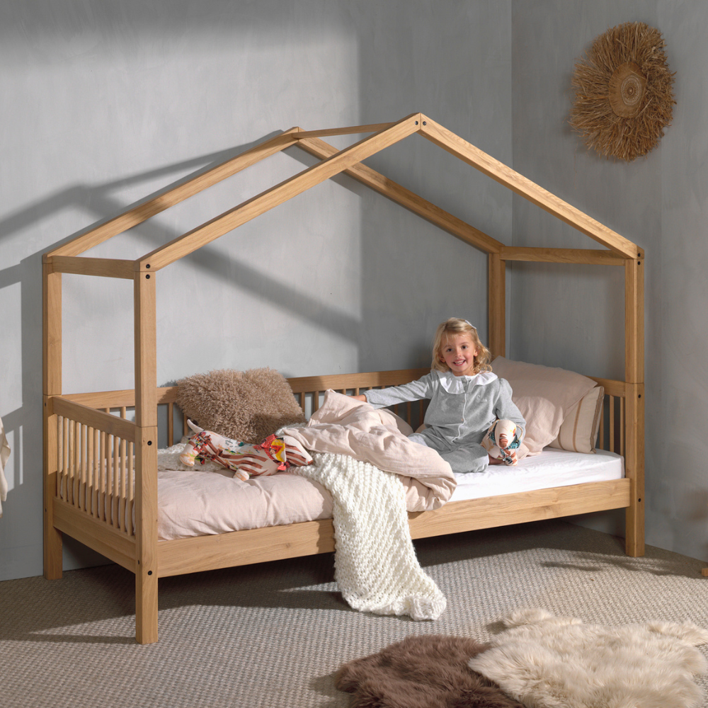 The Forrest Oak Kids House Bed Set with a Textile features a, textile draped over the roof, 3 side guardrail & a sturdy oak frame, ideal for kids aged 4+