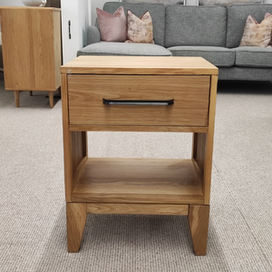 The Viento Bedside Locker Nightstand features a timeless oak build, sleek design with black handles, and ample storage.