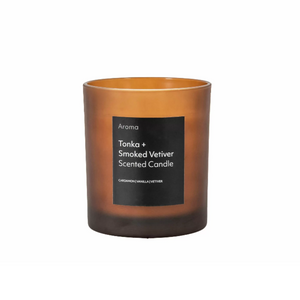 The Gallery Aroma Tonka & Smoked Vetiver Candle in amber glass, 45-hour burn, earthy tonka & vetiver scent for a cozy ambiance.