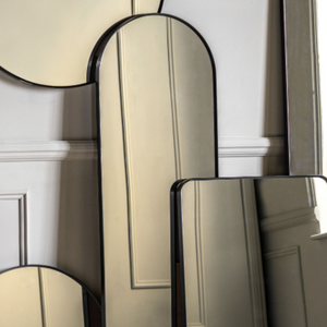 Elevate any room with the Gallery Holworth Arch Mirror in Black featuring a black frame, elegant arch design & versatile style