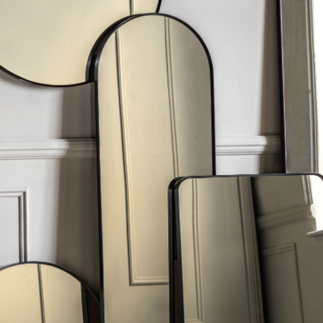Elevate any room with the Gallery Holworth Arch Mirror in Black featuring a black frame, elegant arch design & versatile style