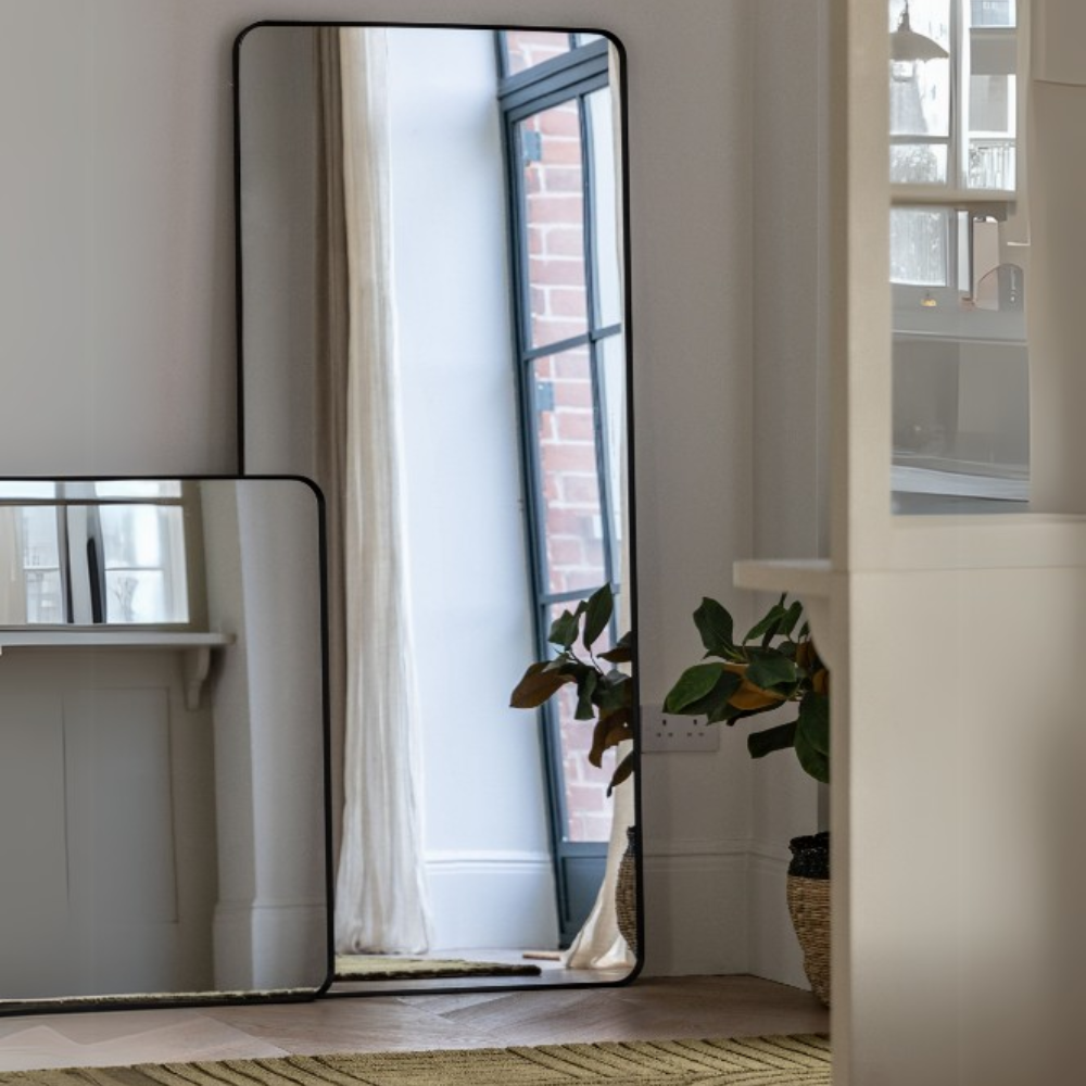 The Gallery Holworth Leaner Mirror in Black offers a sleek frame and full-length design, perfect for any modern or classic space.