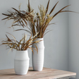 The Gallery Larson Small Vase in White made from terracotta offers a matte finish, ideal for displaying flowers or an accent piece.