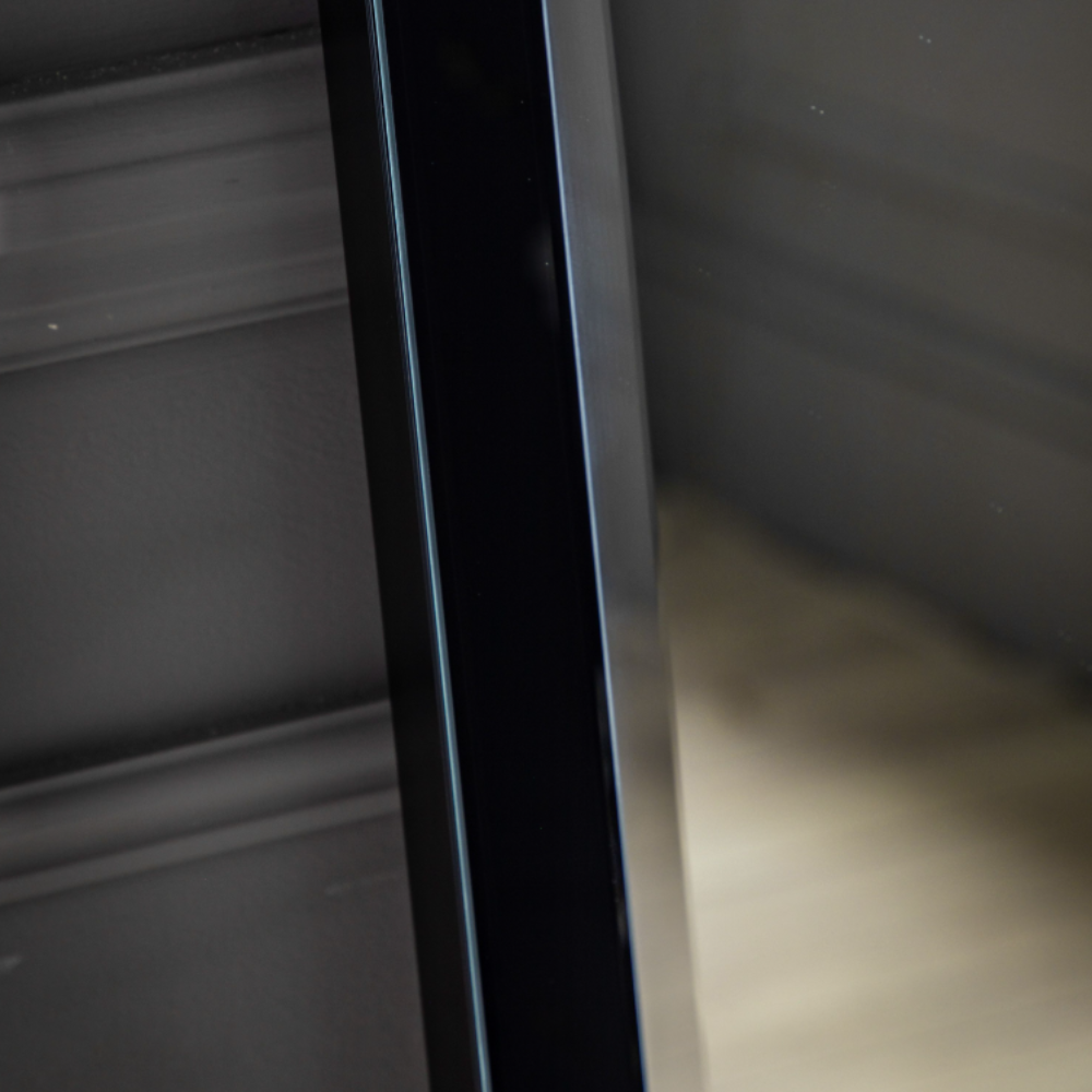 The Gallery Luna Large Mirror in Black features bevelled glass, angled frame, large versatile hanging or leaning options