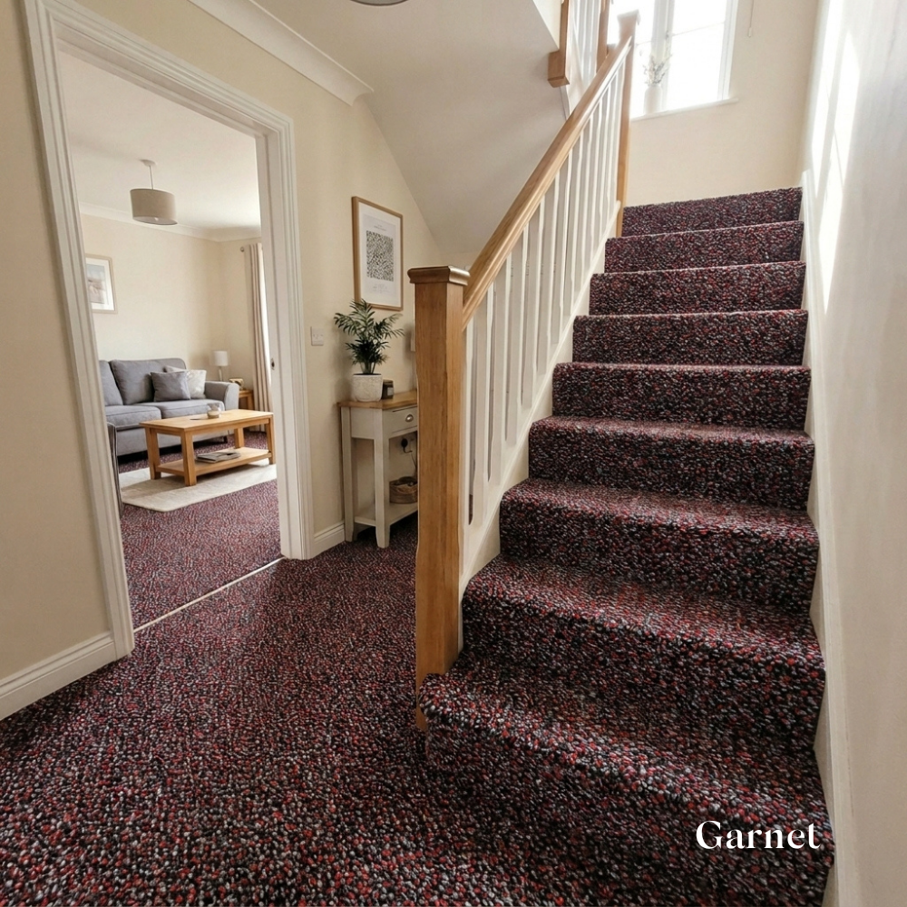 Staircase with garnet carpet leading to a living room.