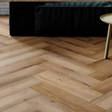 The Georgetown Oak Herringbone SPC Flooring features a timeless oak design, suitable for underfloor heating, Titanium Nano finish and a 25 year warranty