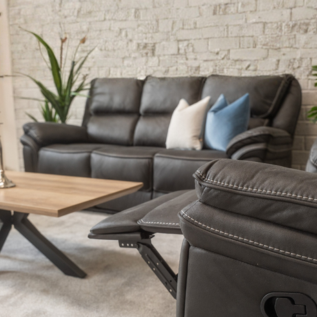 The Glendale Recliner Sofa in Slate Navy features a stylish recliner offering plush comfort, smooth recline and a touch of modern elegance for any home