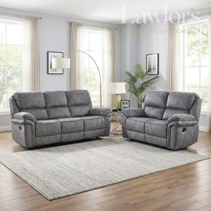 A dark grey 3+2 fabric reclining sofa setarranged in a bright living room with wood floors, a light rug, windows, curtains, a floor lamp, and a plant.