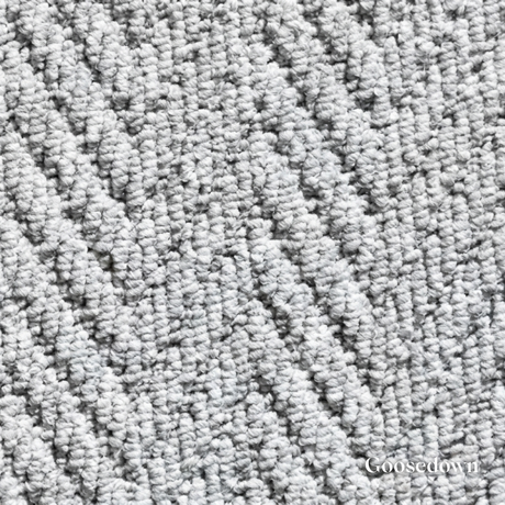 Close-up of textured gray carpet with 'Goosedown' branding.
