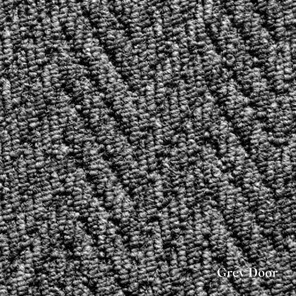Close-up of textured grey carpet with 'Grey Door' branding.