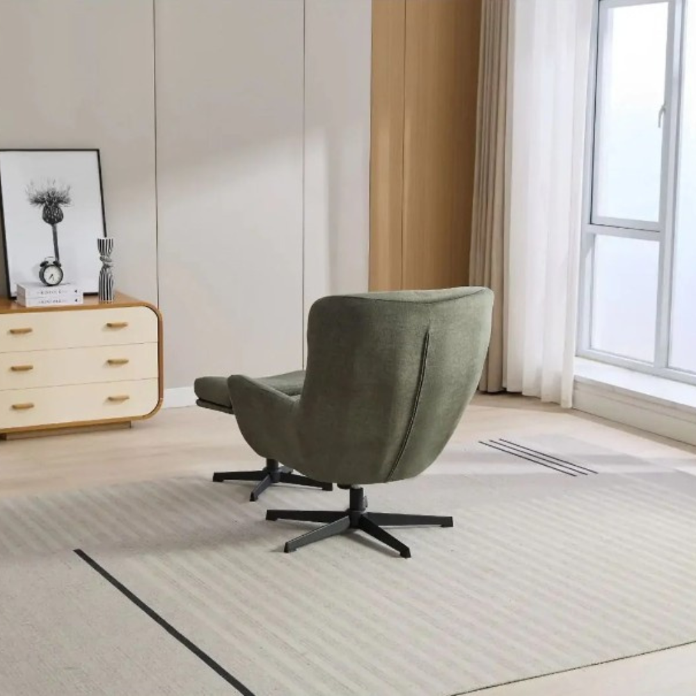 The Idris Swivel Chair & Footstool in Deep Ocean & Winter Moss features 360° rotation, plush comfort and sturdy metal base for stylish relaxation