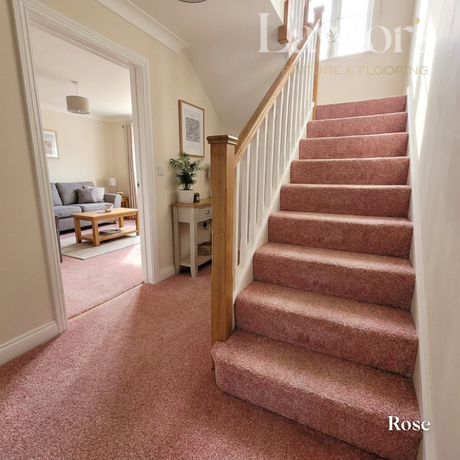 Staircase with rose-colored carpet leading to a living room