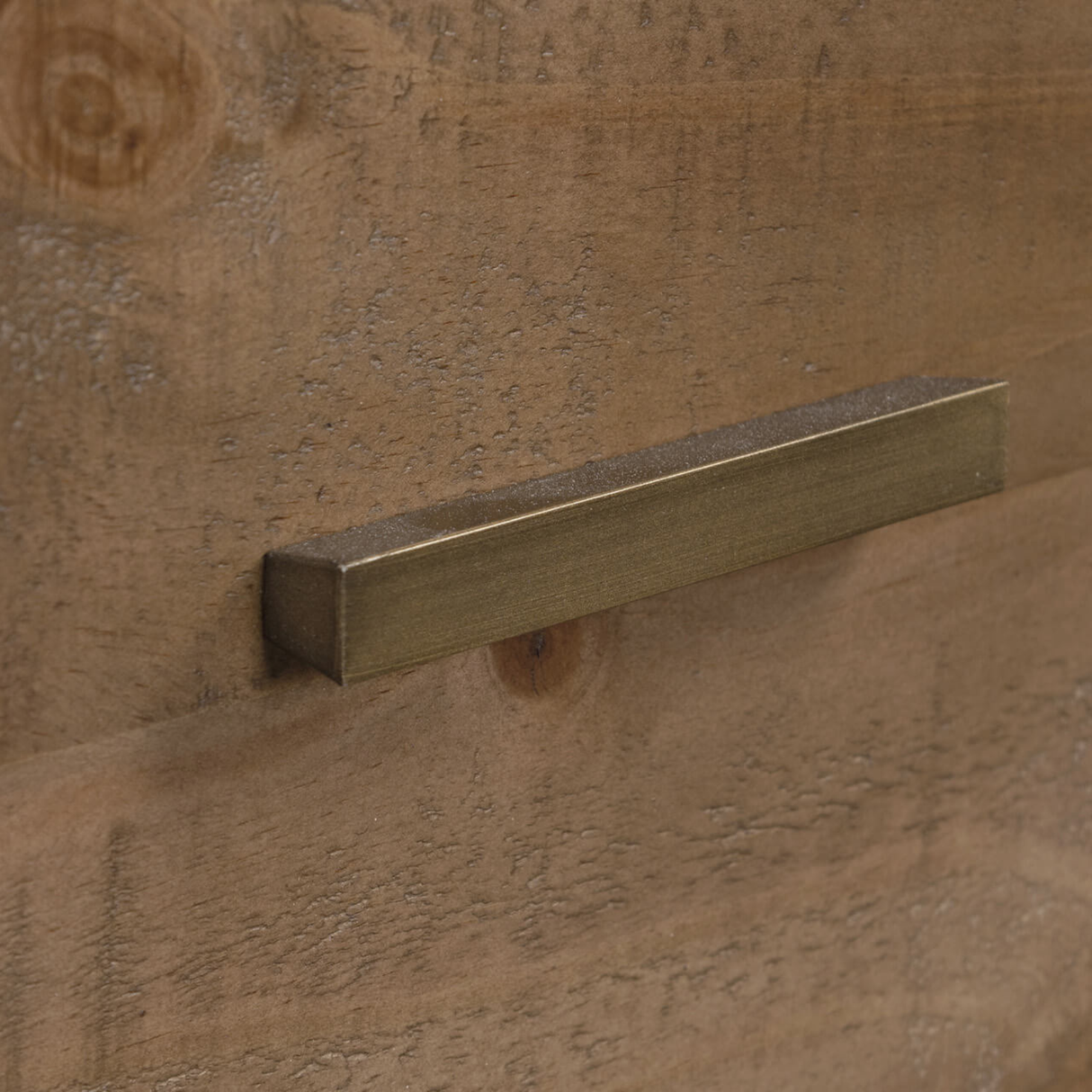 Brass handle on a wooden surface